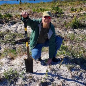 Planting a longleaf pine seedling at Tyndall Air Force Base, following Hurricane Michael cleanup.